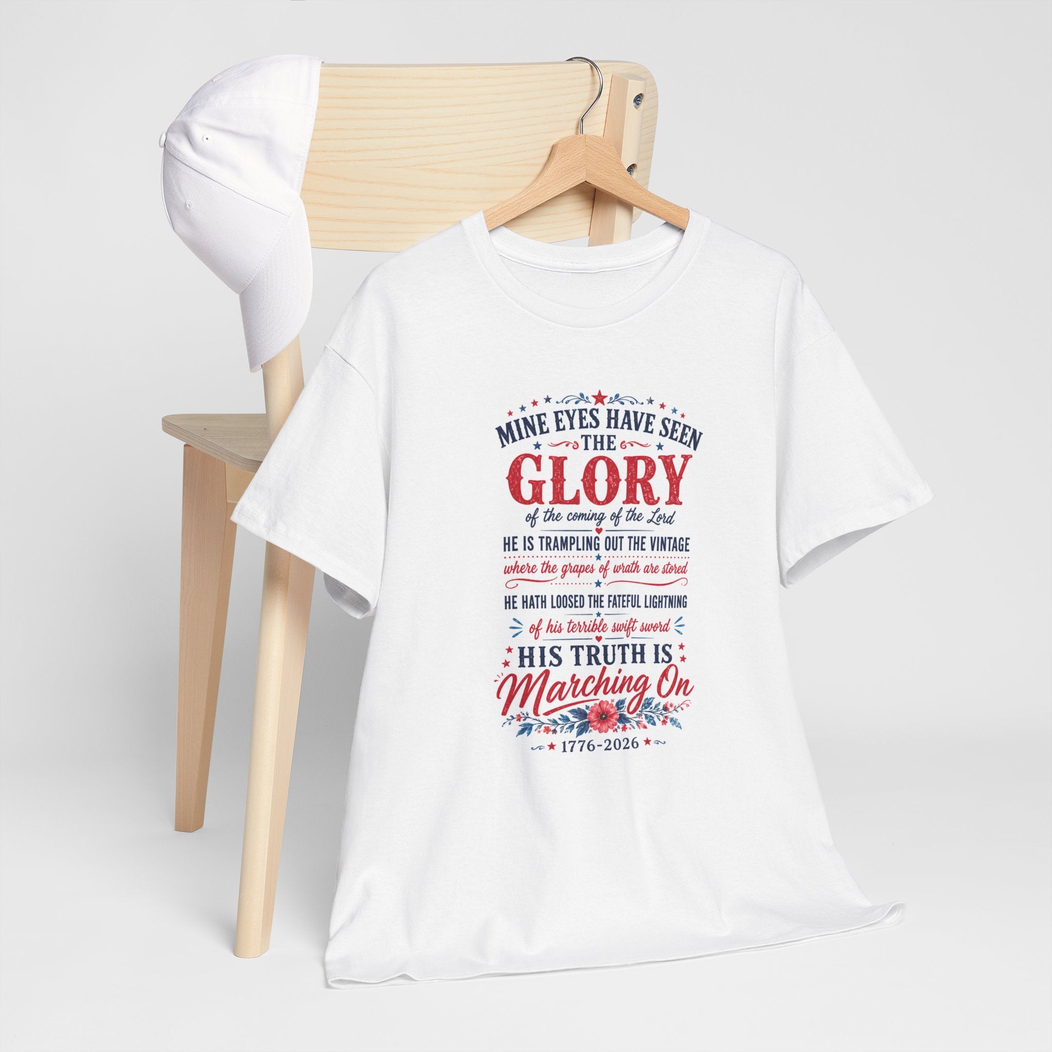 White t-shirt with text and floral design on a wooden hanger against a white background