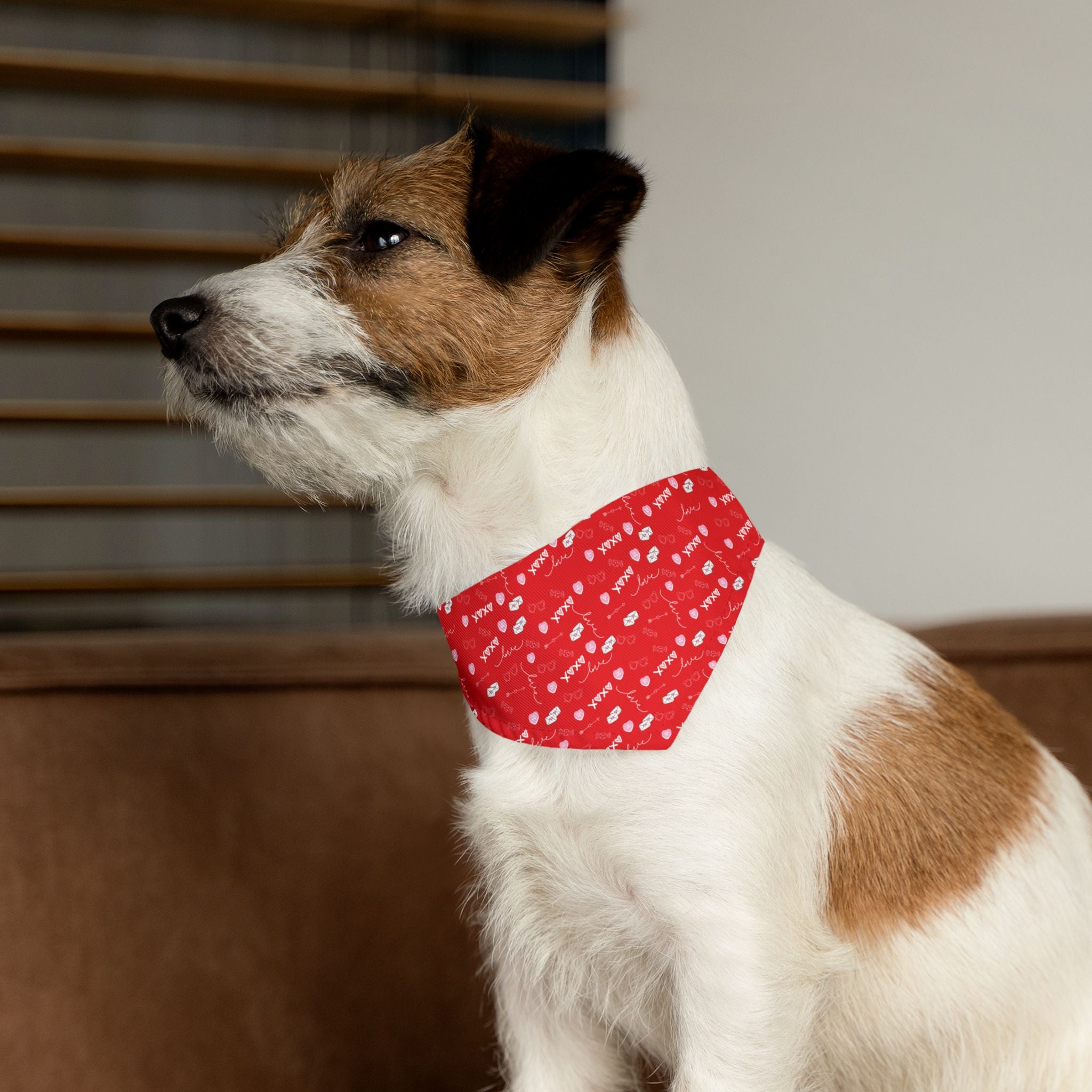 Dog wearing a red bandana with white patterns indoors