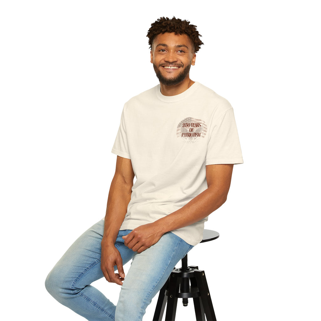 Man sitting on a stool wearing a white t-shirt with a logo and light blue jeans against a white background