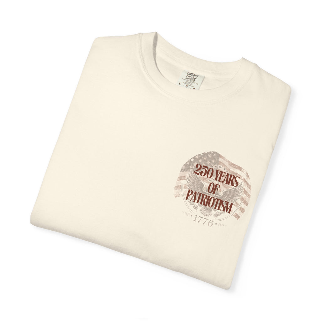Folded cream-colored t-shirt with a graphic design and text on a white background